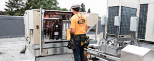 Steele Electric Master Electrician inspects rooftop commercial HVAC unit during Oregon electrical code inspection service.